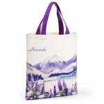 Cream pure cotton tote with purple handles and a purple watercolour mountain and lavender print with script text.