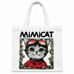 White pure cotton tote bag with natural handles and a full-colour cartoon cat illustration with black MIMICAT lettering.